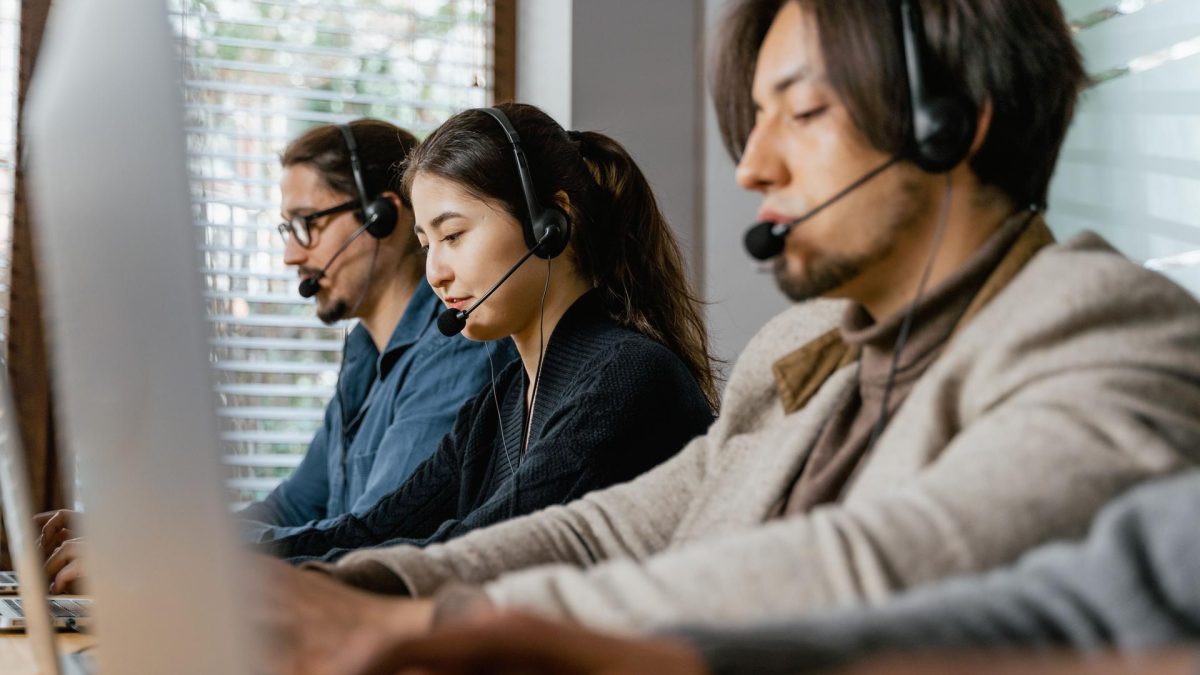Call center agents discussing implications of AI laws on tech safety and regulation.