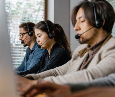 Call center agents discussing implications of AI laws on tech safety and regulation.