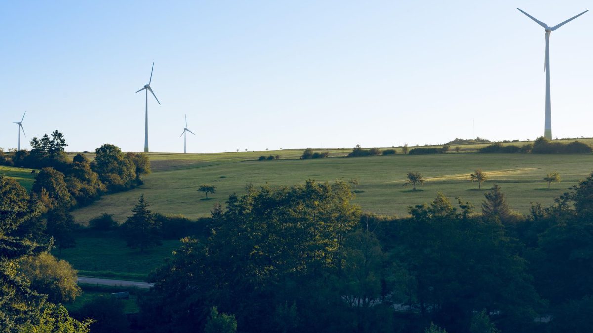 Wind turbines symbolize sustainable infrastructure essential for AI's long-term development, reflecting trends in AI news.