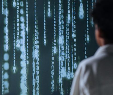 Person in a lab coat views digital data display, highlighting AI's complexities and the importance of ai laws.