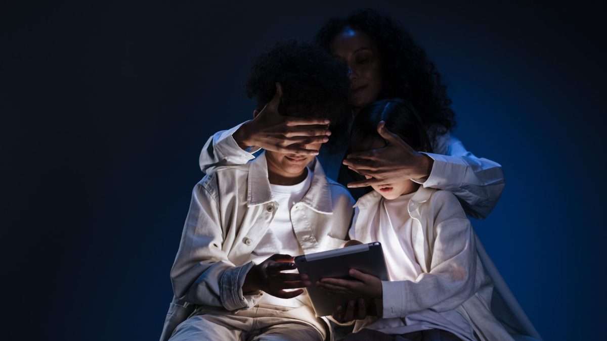An adult obscuring children's faces while they engage with a tablet, highlighting user privacy concerns in AI agents.