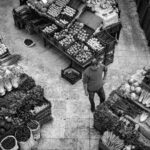 Overhead produce market scene illustrating consumer choices and demand for transparent AI ad disclosure.