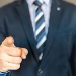 Man pointing toward viewers while considering trust in AI-generated advertising and brand referrals