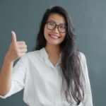 Smiling woman giving a thumbs-up while considering whether to recommend an AI advertiser
