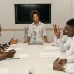 Colleagues discuss shared safety standards for responsible AGI development in a conference room.